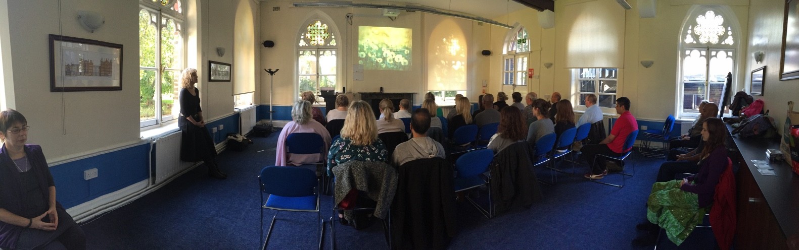Large group of people watching SOS Method presentation